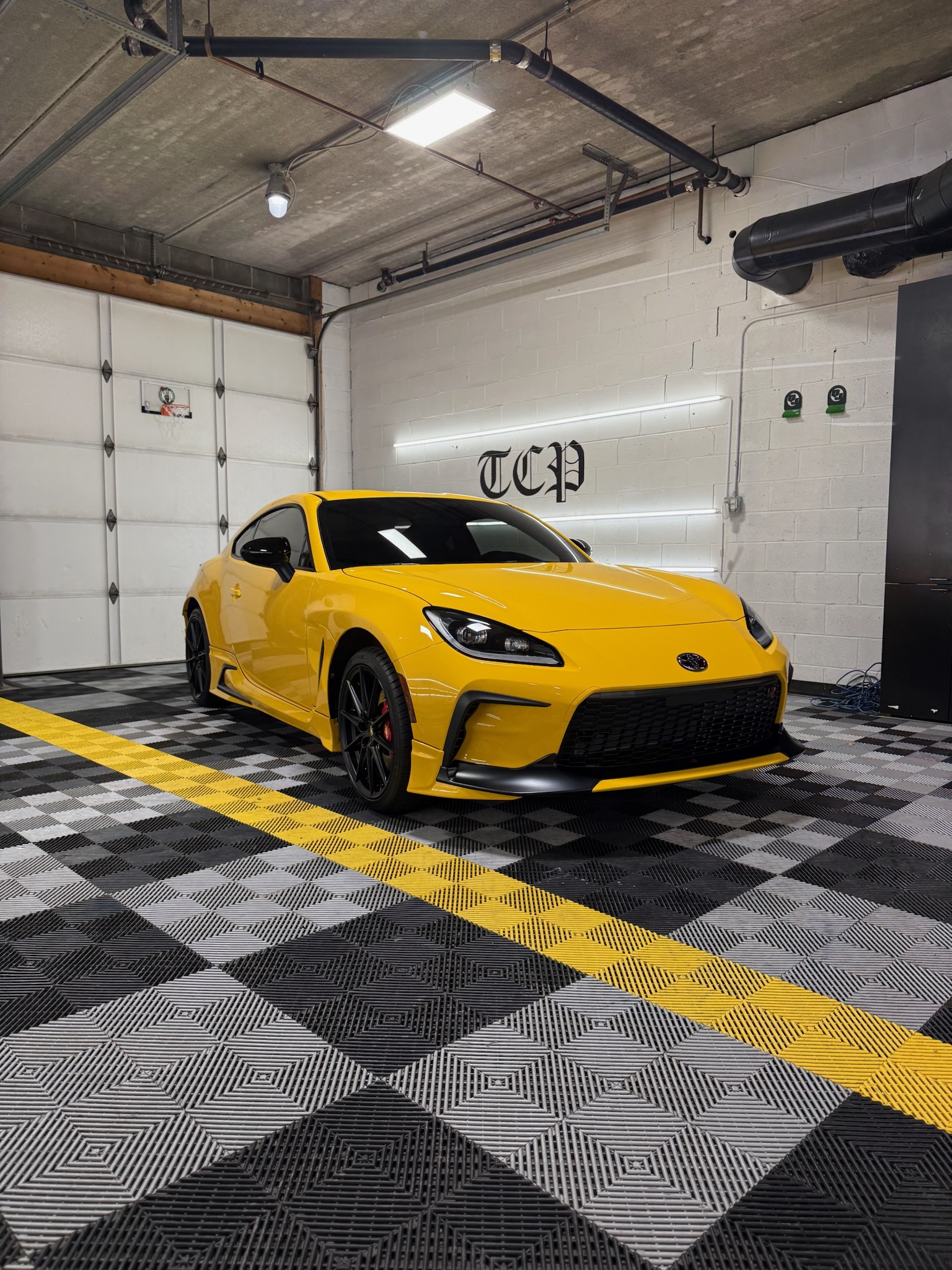 Glossy protective ceramic coating being applied to a clean vehicle surface